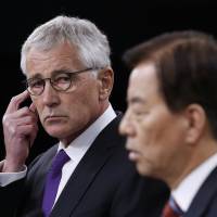 U.S. Secretary of Defense Chuck Hagel listens to South Korean National Defense Minister Han Min Koo during a news conference at the Pentagon on Oct. 23. | REUTERS