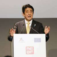 Prime Minister Shinzo Abe gives a speech to a group of business leaders Thursday in Milan ahead of a two-day summit of the Asia-Europe Meeting, or ASEM, through Friday. | KYODO