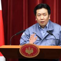 Yukio Edano of the Democratic Party of Japan addresses a news conference in March 2011, when he was chief Cabinet secretary to Prime Minister Naoto Kan. | BLOOMBERG