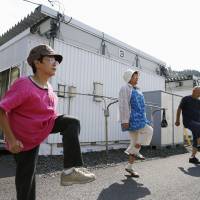Elderly disaster evacuees in the town of Otsuchi, Iwate Prefecture, exercise to NHK Radio\'s calisthenics music in September. The sports ministry\'s fiscal 2013 survey on physical fitness, released ahead of Sports Day on Monday, said elderly women are at the top of their game. | KYODO