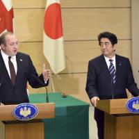 President Giorgi Margvelashvili of Georgia speaks as Prime Minister Shinzo Abe looks on during a press conference at the prime minister\'s office in Tokyo on Friday. | AP