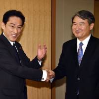 Foreign Minister Fumio Kishida (left) greets South Korean First Vice Foreign Minister Cho Tae-yong at his office in Tokyo on Thursday. | AFP-JIJI