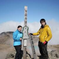 Yuki Tokoro (right) and Yuki Niwa pose at the summit of Mount Ontake on Sept. 27, in a photo recovered from Tokoro\'s camera. | KIYOKAZU TOKORO/KYODO