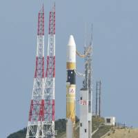 An H-IIA rocket carrying the Himawari-8 satellite is readied for liftoff Tuesday at the Tanegashima Space Center in Kagoshima Prefecture. | KYODO