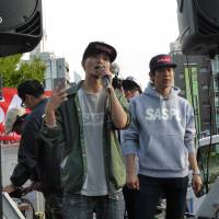 Aki Okuda (center), a 22-year-old political science major, fires up his fellow students before their demonstration in Tokyo\'s Shibuya area on Saturday. | SHUSUKE MURAI