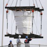 The 1964 Tokyo Olympics caldron was removed by crane from the National Stadium in the capital on Friday. | KYODO