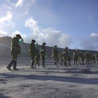 Ground Self-Defense Force troops search for bodies on Mount Ontake last week. The effort continued Sunday for seven people still missing after the volcano erupted Sept. 27, killing at least 56. | REUTERS