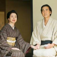 Painfully honorable: Samurai Shukoku Toda (Koji Yakusho) with his wife (Mieko Harada). Shukoku has been unjustly sentenced to commit ritual suicide, and awaits death by documenting his clans\' history. | &#169; 2014 \"HIGURASHI NO KI\" FILM PARTNERS
