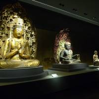 Enlightened: \"Seated Dainichi Nyorai\" (far left) and \"Seated Fudo Myoo\" (next right) on display at the Heisei Chishinkan wing of the Kyoto National Museum. | SACHIKO TAMASHIGE