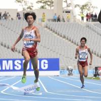 Photo finish: Bahrain’s Ali Hasan Mahboob (right) crosses the line to win the men’s marathon at the Asian Games on Friday ahead of Kohei Matsumura (left) and Yuki Kawauchi. Japanese pair miss out to Mahboob