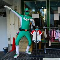 Green hero: “Babycar Orosunja” poses outside his shop. | KIT NAGAMURA