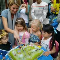 Minister Counsellor Victoria Forslund Bellas of the Swedish Embassy cuts the traditional Swedish princess cake on Oct. 11 during the Sweden Kids Week event. | CHIHO IUCHI