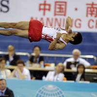 The right stuff: Kenzo Shirai twists in the air during the men\'s apparatus final at the Artistic Gymnastics World Championships in Nanning, China, on Saturday. Shirai earned the silver medal. | AP