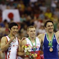 Cream of the crop: Gold medalist Denis Abliazin of Russia (center), Japan\'s siliver medalist Kenzo Shirai (left) and bronze medalist Diego Hypolito of Brazil pose on the podium after the men\'s apparatus final at the Artistic Gymnastics World Championships in Nanning, China, on Saturday. | AP
