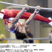 Silver lining: Kohei Uchimura performs on the horizontal bar at the world championships in Nanning, China, on Sunday. | KYODO
