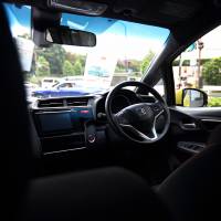 A Honda Motor Co. Fit Hybrid is seen in Tokyo on Oct. 23. A defect in Takata Corp. air bags is linked to four deaths in Honda cars. U.S. regulators are now examining whether the automaker failed to report the problems as required. | BLOOMBERG