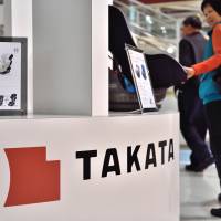Takata Corp. products are displayed in an auto showroom in Tokyo on Tuesday. | AFP-JIJI