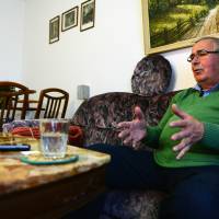 Harald Jaeger, a retired lieutenant colonel in the former east German secret police who is credited with opening the Berlin Wall, speaks to journalists Saturday at his home in Werneuchen, Germany. | AFP-JIJI