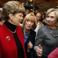 Hillary Rodham Clinton (right), alongside U.S. Sen. Jeanne Shaheen (left) and New Hampshire Gov. Maggie Hassan (center), both fellow democrats, greets voters at the Backroom Restaurant on Sunday in Manchester, New Hampshire. | AP