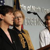 Dr. Megan Davies (left), North Carolina state epidemiologist, speaks as Drs. Aldona Wos (center), the state\'s secretary of health services, and Lisa Pickett, chief medical officer at Duke Medical Center, look on at a press conference Sunday in Raleigh to announce that a person is being monitored for Ebola at Duke University Hospital. | AP