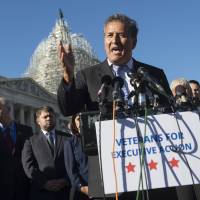 U.S. Rep. Juan Vargas, Democrat from California, speaks as U.S. veterans, service members and immigration reform advocates look on, during a press conference urging President Barack Obama to move forward with immigration reform at the U.S. Capitol on Wednesday. | AFP-JIJI