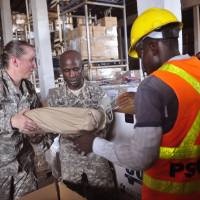 American soldiers sort through Ebola virus protection equipment to be used by USAID-sponsored Ebola clinics across the country in Monrovia, Liberia, Wednesday. Campaigning is underway for Senate elections in Liberia, another sign that Ebola is loosening its deadly grip on the West African country even as it hits the capital of neighboring Sierra Leone with increasing force. Liberia hopes for no new Ebola cases by new year