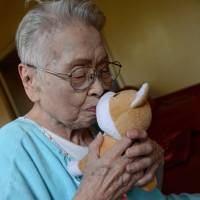 Sakai kisses a stuffed animal which she calls \"Jeff\" in her apartment in Osaka. | BLOOMBERG