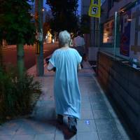 Sakai walks near her home at night in Osaka. | BLOOMBERG