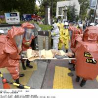 Firefighters practice evacuating victims from Tokyo\'s Hibiya Station as part of a terrorist-attack simulation on the Tokyo subway system on Thursday. | KYODO