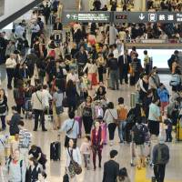 Passengers crowd Narita International Airport during Golden Week last May. | KYODO