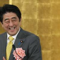 Prime Minister Shinzo Abe reacts as he speaks during a new year\'s gathering for business leaders in Tokyo on Jan. 7, 2014. | Bloomberg