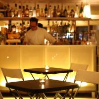 An employee works in Momo, a restaurant in Tokyo\'s Omotesando district, on Friday. Momoko Nakafuji, who helps her parents run the establishment, said she initially welcomed the Tabelog.com restaurant-review website, but now believes the service has done harm than good. | BLOOMBERG
