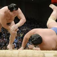 No doubt about it: Yokozuna Hakuho defeats ozeki Kotoshogiku on the 13th day of the Kyushu Grand Sumo Tournament on Friday.  | KYODO