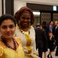 Elizabeth Onogwu, a native of Benue State in Nigeria and a doctoral candidate in anthropology at Yokohama National University, attends a celebration of Nigerian independence held by the Embassy of Nigeria in October. The number of African students at Japanese universities is growing steadily, according to the Japanese government. | DREUX RICHARD