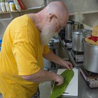 Davis cuts a shell ginger leaf for wrapping one of his cheeses in. | STEPHEN MANSFIELD