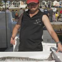 A local fisherman displays a prize salmon, freshly caught for sale at the Revival Market. | SKYE HOHMANN