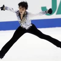 True grit: Yuzuru Hanyu performs his free program at the NHK Trophy on Saturday in Osaka. Hanyu placed fifth with 229.80 points, but still managed to qualify for the Grand Prix Final.  | AP