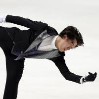 Show business: Takahito Mura skates to \"Phantom of the Opera\" during the free program on Saturday. He placed third with 234.44 points. | AP