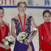 Recognition for success: Winner Gracie Gold (center), second-place skater Alena Leonova of Russia (left) and third-place finisher Satoko Miyahara are seen at the women\'s awards ceremony at the NHK Trophy on Saturday in Osaka. | AP