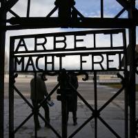The slogan \"Arbeit macht frei,\" or \"Work sets you free,\" is seen on the main gate of the former Nazi concentration camp at Dachau, near Munich, in January. German police said Sunday that the part of the gate that bears the slogan has been stolen. | REUTERS