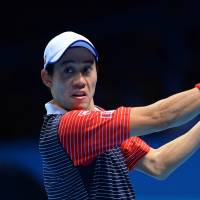 Kei Nishikori hits a return to Spain\'s David Ferrer during the ATP Finals in London on Thursday. Nishikori defeated Ferrer 4-6, 6-4, 6-1 in his final round-robin match and advanced to the semifinals of the prestigious event. | AFP-JIJI