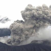 An aerial photo taken Wednesday shows steam and ash billowing from Mount Aso in Kumamoto Prefecture, although a local observatory said it had detected no sign of intensifying vigor at the nation\'s largest active volcano. | KYODO