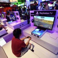 People test the new Playstation TV consoles at the annual E3 video game extravaganza, where game-makers battle for the market share. Online hackers took credit for an online service outage of Sony\'s PlayStation and Microsoft\'s Xbox game consoles on Dec. 25, 2014 as people unwrapped their new toys on Christmas morning. | AFP-JIJI