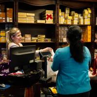 Tourists buy cigars at a store in Havana, on Thursday.   Celebrations broke out on the streets of Havana as people savored the prospect of an end to the five-decade-old U.S. trade embargo and perhaps a brighter future. | AFP-JIJI