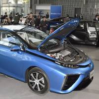 Toyota Motor Corp.\'s new Mirai vehicle is displayed at the Miraikan museum in Tokyo on Monday. Toyota has become the world\'s first automaker to market a hydrogen-powered car. | KYODO