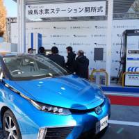 A Toyota Mirai fuel cell vehicle is displayed during a ceremony Thursday at Tokyo Gas Co.\'s first commercial hydrogen refueling station in Nerima Ward, Tokyo. | KAZUAKI NAGATA