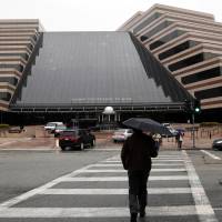 Pedestrians cross the street in front of the Sony Pictures Entertainment headquarters in Culver City, California, on Tuesday. The FBI has confirmed it is investigating a recent hacking attack at Sony Pictures that caused major internal computer problems at the film studio last week. | AP