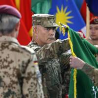 U.S. Gen. John Campbell, commander of the NATO-led International Security Assistance Force, folds the flag of the ISAF during the change of mission ceremony in Kabul on Sunday, when the American-led coalition officially ended its combat mission after a more than 13 year war that ousted the Taliban government in 2001. | REUTERS