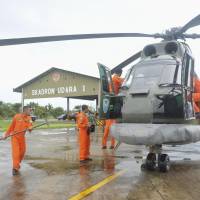 A search and rescue squad from the Indonesian Air Force prepares to depart on a Puma helicopter to take part in the search for missing AirAsia Flight QZ8501, from a base in Kubu Raya, West Kalimantan, on Sunday. The Airbus 320-200 lost contact with Jakarta air traffic control at 6:17 a.m. local time, officials said. | ANTARA FOTO/REUTERS