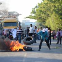 Protesters set tires alight as work begins on a $50 billion China-backed interoceanic canal in Rivas, Nicaragua, on Dec. 22. Doubts over ambitious Nicaragua canal project grow as work gets underway